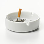 A crushed cigarette butt in an ashtray.