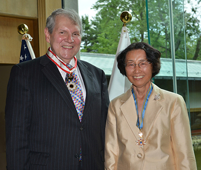 Photograph of the researchers smiling and wearing their honorary ribbons in 2012.