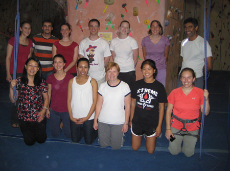 Lab members pose for a photo in a rock climbing gym.