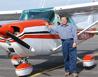 Dr. Gary Shen standing next to plane.