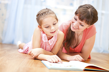 Daughter reading with mother