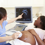 Pregnant woman and partner having 4d ultrasound scan