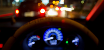 Stock image of an out-of-focus car dashboard at night