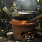 Indoor stove with smoke rising from its fire while cooking