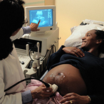 Pregnant woman getting a sonogram at the doctor's office
