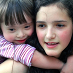 Two young girls playing and smiling