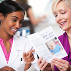 Two women looking at a medical brochure