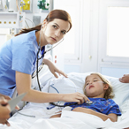 Hospital staff attend to a child in bed in the pediatric critical care ward, while the child’s mother stands by the bed