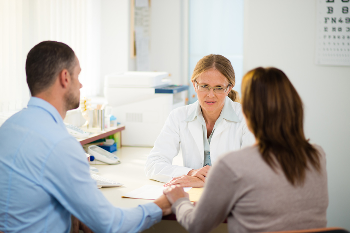 Man and woman with their health care provider