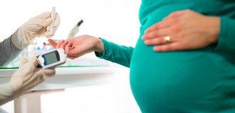 pregnant woman having her blood sugar tested