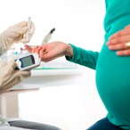 pregnant woman having her blood sugar tested