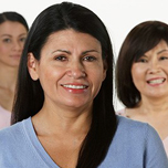 Group of women of different ethnicities and sizes standing together and smiling at the camera