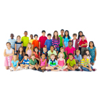 Large group of children of different ages, sizes, and ethnicities wearing different colored shirts. Some are sitting, and some are standing.