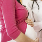 Pregnant woman in health care provider’s office getting prenatal care