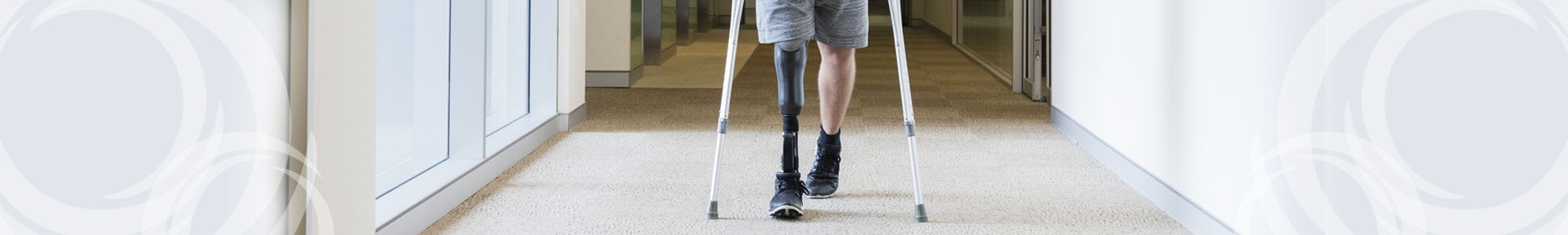 A man with a prosthetic leg using crutches
