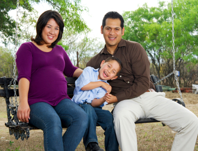 A family sitting on a bench