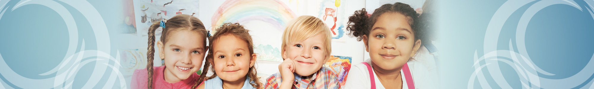 Four children smiling and coloring