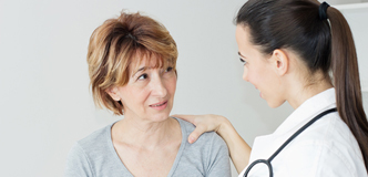 Stock image of a woman talking with a physician
