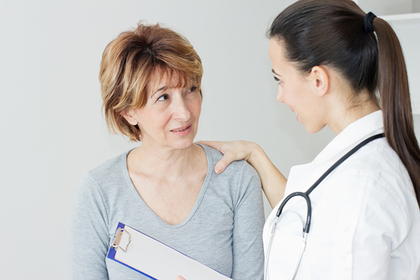 Woman talking with a healthcare provider.