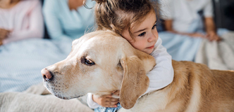 Young girl hugging dog