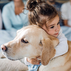 Young girl hugging dog