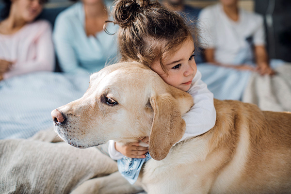 Young girl hugging dog