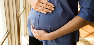 Stock image of a pregnant woman’s abdomen.