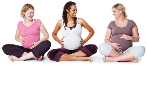 Pregnant women sitting together in a row.