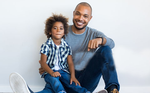 A father and son sitting.