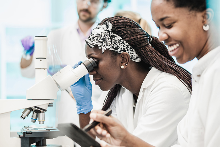 Scientist looking into a microscope.