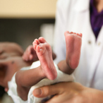 A healthcare worker holding a newborn.