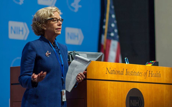 Dr. Bianchi standing at a podium.