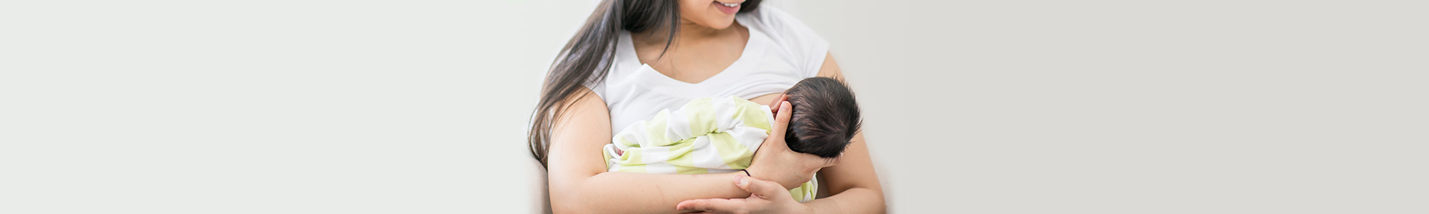 A mother breastfeeding her newborn baby.