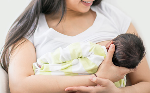 A mother breastfeeding her newborn baby.