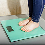 A child’s feet on a bathroom scale.