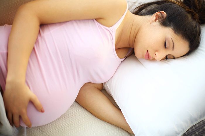 Pregnant woman sleeping on her left side.