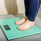 Child’s feet on a bathroom scale.