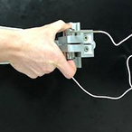 A hand holding the device used to measure grip strength.