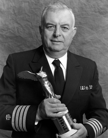photo of Dr. John B. Robbins holding the Albert Lasker Clinical Medical Research Award wearing his Public Health Service uniform