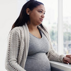 Pregnant woman consulting with health provider.