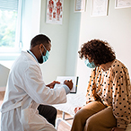 Medical provider taking information from patient.