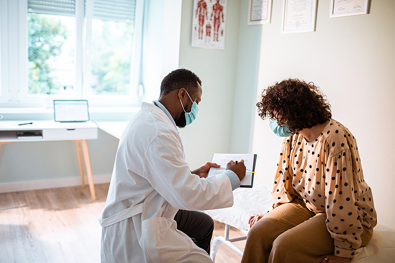 Medical provider taking information from patient.