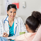 Physician talking to parent and child.