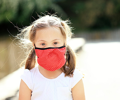 Girl wearing protective face mask. 