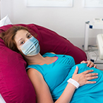 Pregnant woman lying on examining table.