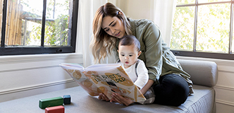 Woman and infant looking at picture book.