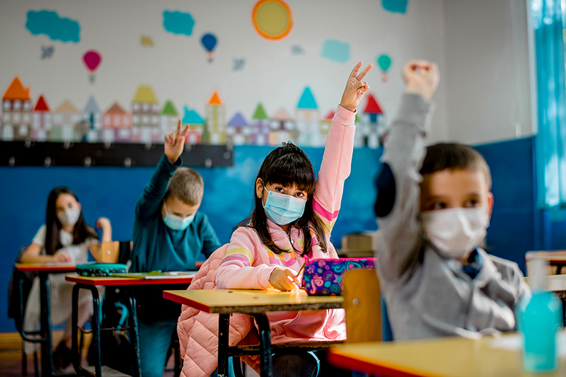 Elementary school children wearing face masks in the classroom.