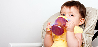 Child drinking from a sippy cup.