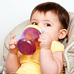 Child drinking from a sippy cup.