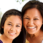 Two young women smiling.